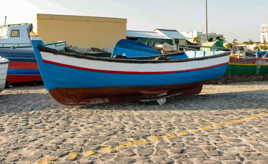Fishing boat, traditional Portuguese, painted blue and white, in the marina of Setubal