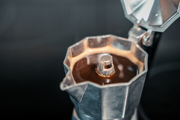 close up of a stove with hot coffee inside