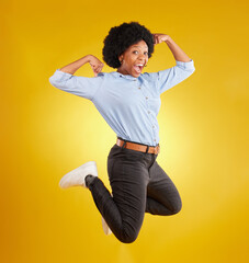 Jump, muscle flex and portrait of black woman on yellow background with energy, happiness and smile in studio. Success mockup, celebration and isolated happy girl jumping for freedom, winning and joy