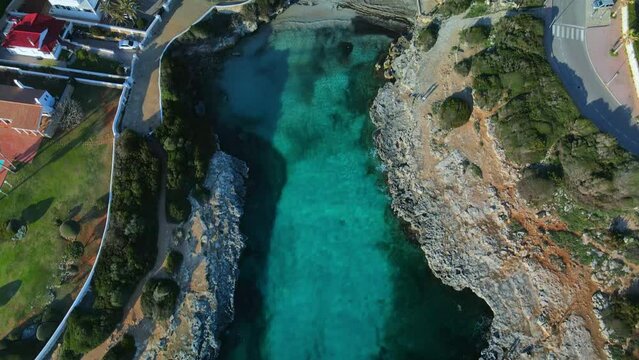 cinematic drone flight over beach front property in Sa Caleta, Menorca island Spain.