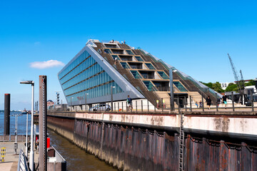 Dockland office building at Dockland Ferry Wharf (Fischereihafen). A large trapezoid building...