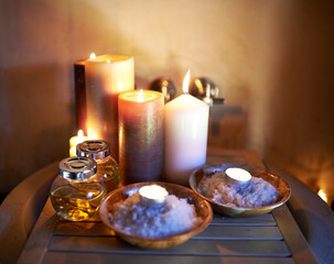 Body balance and a little zen. An arrangement of scented candles, salts and oils at a spa.