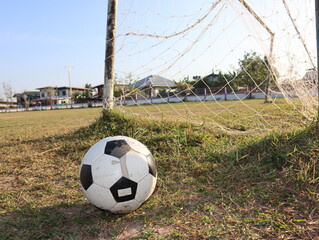 football near the net of the post.