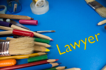 Overhead shot of school supplies with Lawyer text. Brushes, pencils, artistic tools. Art And Craft Work Tools.