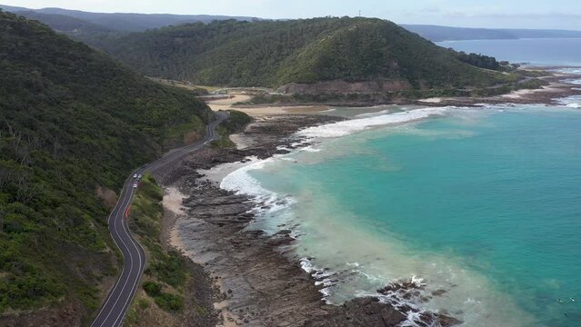 Iconic Great Ocean Road aerial view with Teddy's Lookout hill in background, Victoria, Australia