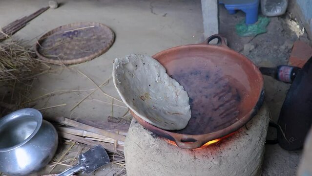 rice floor bread making in traditional soil vessels at wood fire from different angle