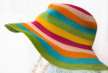 Straw multi-color summer hat on white background. Elegant hat with wide margins. Women beach,...