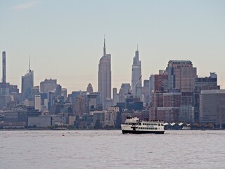Looking back on Manhattan from the Hudson River and Liberty Island, as the towering high rises of...