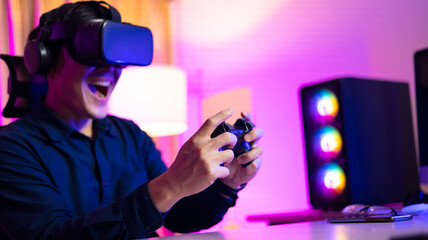 VR Headset. Asian man playing game on mobile phone with 3D simulation VR headset. Colorful neon light room. Esport online game.