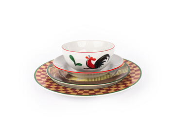 Red and yellow ceramic plate and white chicken bowl on top Isolated on white background
