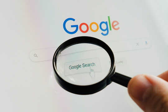 Sankt- Google homepage on the monitor screen under a magnifying glass. Google is world's most popular search engine