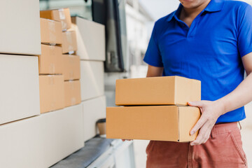 delivery concept Asian male customer receiving boxes from professional courier at home.