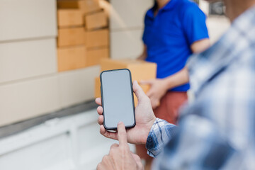 delivery concept Asian male customer receiving boxes from professional courier at home.