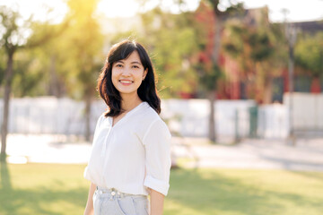 Portrait young beautiful asian woman with happy smile around outdoor park in sunny summer day