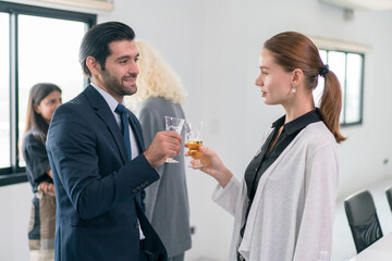 Corporate co-workers having drinks after meeting, People clinking glasses with sparkling wine indoors, Business people celebrating inside modern office.