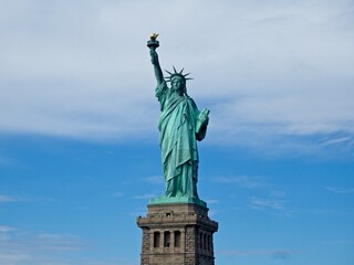 The Statue of Liberty sits on Liberty Island in the New York Harbor. It was once a beacon of hope for immigrants arriving by steamship into the United States