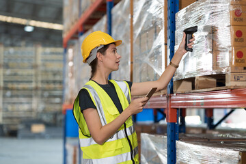 Caucasian female female warehouse worker working at work scanning barcode on products boxes for...