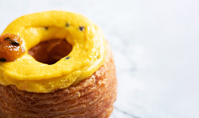 Croissant donuts with whipped cream on a marble background