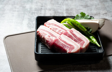 Samgyeopsal, mushrooms and vegetables on a plate	