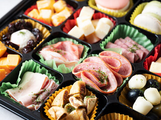 A variety of cheeses, raw hams and sweets	