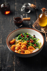 Portion of asian rice dish with shrimp and spinach