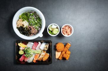 Sushi and side menu in takeout containers