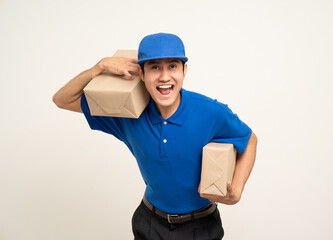 Asian man in blue uniform standing holding box parcel cardboard and smartphone on isolated white background. Male service worker with cell phone. Delivery courier shipping service