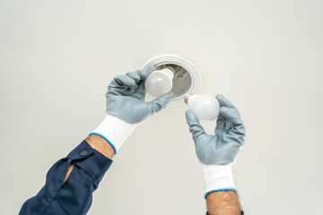 Electrician installing led light bulbs at home for power saving. Fixing changing the Light Inside...