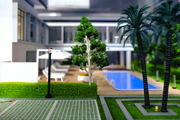 Naklejka premium Overview of luxury patio of modern contemporary miniature model housing. Focus on the tree model. Construction, home architecture, property and real estate concept