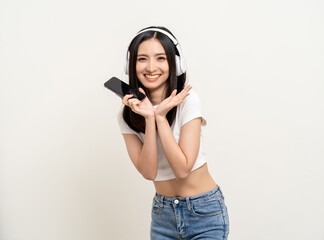 Beautiful young asian women choose song and play music from smartphone connection with wireless headphone having fun. Teenage girl listen to the music enjoy relaxing on isolated white background.