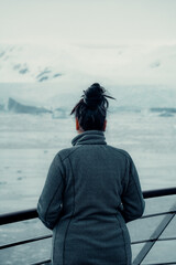Young Woman On Cruise Looking Out At Snowy Landscape in Antarctica, Tourist Enjoying Nature
