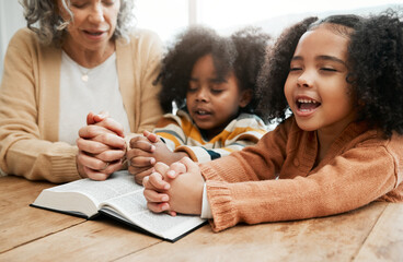 Bible, worship or grandmother praying with kids or siblings for prayer, support or hope in Christianity. Children education, family or old woman studying, reading book or learning God in religion