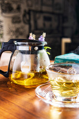 Warm cup of tea with teapot on the wooden desk. Organic product from the nature for healthy with traditional. - 581676912