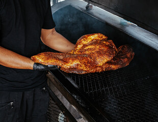 Men using tongs gently flips pieces of meat on burning barbecue.. Grilled beef steak on the grill, close-up. - 581676976