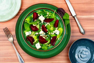 Salad with beet, cheese and pine nuts,top view
