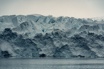 Massive Glacier Cliff In Antarctica, Moody Landscape