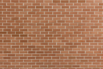 Modern and stylish orange red and brown colored brick pattern textures are regularly listed and stacked with a pile of stone material background