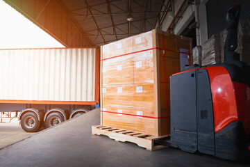 Package Boxes Wrapped Plastic Stacked on Pallets Loading into Cargo Container. Trucks Loading Dock Warehouse. Shipping Supply Chain Shipment. Freight Truck Logistics Cargo Transport	