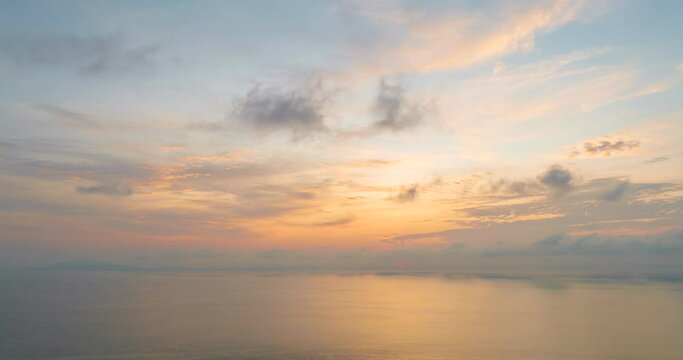 4K Time lapse of colorful sunrise or sunset landscape background. Amazing light of nature blue sky pastel pink moving cloud and golden yellow cloudscape timelapse in tropical summer spring sunlight.