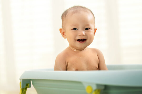 Lovely baby sat on the tub bath