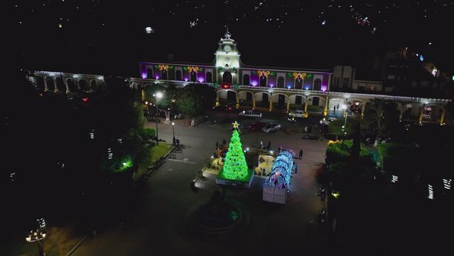 Night View Of Traffic And Mexican People In Front Of The City Hall In Ciudad Guzman During Christmas Season In Jalisco, Mexico. aerial