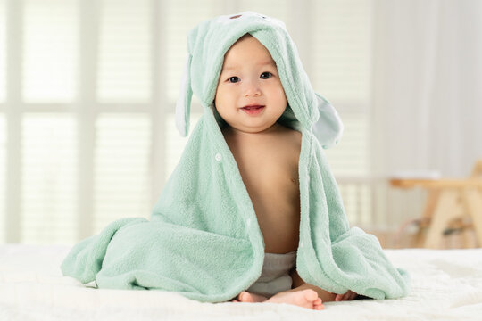 Playing cute baby sitting on the bed
