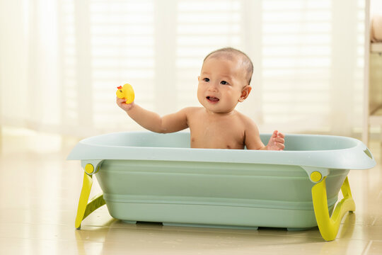Lovely baby sat on the tub bath