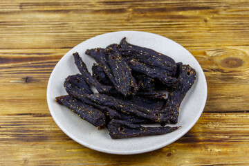 Slices of biltong (South African dried meat) on wooden table