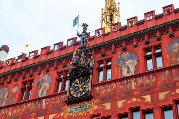 Obraz premium Close-up of red town hall with clock, paintings and ornaments in Basel, Switzerland