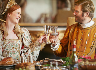 May fortune look down upon our house with favor. a noble couple toasting while eating together in...