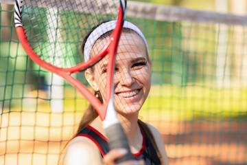Professional girl athlete playing tennis on court. female player with racket, ball near net outdoor. healthy sport active lifestyle. lady with ceramic braces to align bite teeth