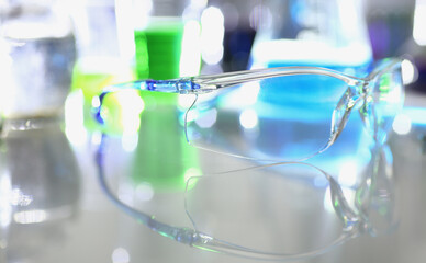 Transparent glasses and chemical liquids in test tubes in laboratory