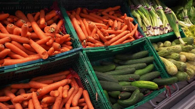 Vegetables in the supermarket on the counter for sale.