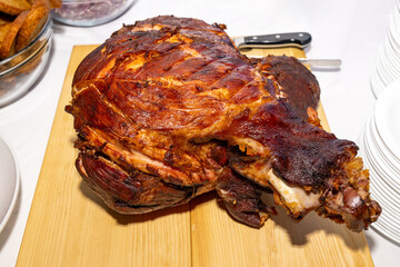 Grilled ham hock until crispy on a wooden plank